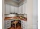 Home office featuring custom built-in cabinets with a granite countertop and natural light at 134 Larkhaven Ln, Mooresville, NC 28117