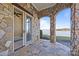 Stone patio with stone arches, outdoor access, and a stunning lake view at 134 Larkhaven Ln, Mooresville, NC 28117