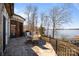 Stone patio with outdoor seating, a grill, and a stunning lake view at 134 Larkhaven Ln, Mooresville, NC 28117