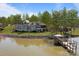 Rear exterior shot featuring a stone facade, covered porch, and stunning waterfront view at 134 Larkhaven Ln, Mooresville, NC 28117