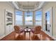 Cozy sitting room with bay windows offering stunning views of the lake and manicured grounds at 134 Larkhaven Ln, Mooresville, NC 28117
