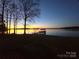 Scenic waterfront view with a charming dock extending into the tranquil water at sunset at 134 Larkhaven Ln, Mooresville, NC 28117