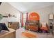 This Bedroom has a sun mural on the wall above a crib with coordinating curtains and decor at 13850 Clayborn St, Midland, NC 28107