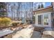 Secluded backyard with a patio, picnic table, and mature trees, perfect for outdoor entertaining and relaxation at 158 Crimson Orchard Dr, Mooresville, NC 28115