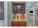 Bar with granite countertops and glass door display cabinets at 158 Crimson Orchard Dr, Mooresville, NC 28115
