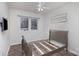 A cozy bedroom featuring a wooden bed frame, a window with blinds, and wood flooring at 158 Crimson Orchard Dr, Mooresville, NC 28115