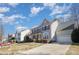 Charming two-story home with a well-manicured front yard, a porch, and a two-car garage at 158 Crimson Orchard Dr, Mooresville, NC 28115