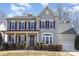 Charming two-story home with gray siding, red shutters, and a welcoming front porch at 158 Crimson Orchard Dr, Mooresville, NC 28115
