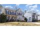 Charming two-story home features a classic design with gray siding, red shutters, and a welcoming front porch at 158 Crimson Orchard Dr, Mooresville, NC 28115