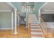 Bright foyer with hardwood floors, staircase, and view into the living room creates an inviting entrance at 158 Crimson Orchard Dr, Mooresville, NC 28115