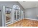 Vaulted living room featuring tall windows and hardwood floors at 158 Crimson Orchard Dr, Mooresville, NC 28115