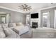 Comfortable living room featuring a fireplace, ceiling fan, and large sectional sofa at 158 Crimson Orchard Dr, Mooresville, NC 28115
