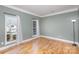 Empty room featuring two windows with hardwood floors and crown moulding at 158 Crimson Orchard Dr, Mooresville, NC 28115