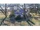 Aerial view of a charming house and expansive lot surrounded by large trees and a wire fence at 169 Eagle Mills Rd, Harmony, NC 28634