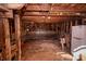 Rustic barn interior with wood frame and dirt floor with refrigerator and saddle at 169 Eagle Mills Rd, Harmony, NC 28634