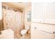 Compact bathroom featuring a shower/tub combo, neutral tile, and vanity at 169 Eagle Mills Rd, Harmony, NC 28634