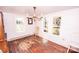 Sunlit dining room boasts hardwood floors and vintage chandelier, offering a classic ambiance at 169 Eagle Mills Rd, Harmony, NC 28634