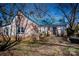 Exterior side view of a charming home with a brick facade and a wooden deck, enhanced by natural light at 169 Eagle Mills Rd, Harmony, NC 28634