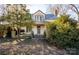Charming historic home with a blue roof, front porch, and mature landscaping at 169 Eagle Mills Rd, Harmony, NC 28634