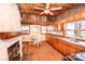 Charming eat-in kitchen with wood-paneled walls and fireplace, offering warmth and character at 169 Eagle Mills Rd, Harmony, NC 28634