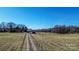 Expansive land featuring a dirt driveway leading up to a barn with plenty of room for activities at 169 Eagle Mills Rd, Harmony, NC 28634