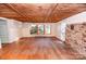 Inviting living room with exposed beam ceilings, brick accents, and outdoor views at 169 Eagle Mills Rd, Harmony, NC 28634