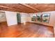 Bright living room with wood floors, exposed beam ceilings, and ample natural light at 169 Eagle Mills Rd, Harmony, NC 28634