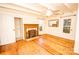 Cozy living room with original hardwood floors, a decorative fireplace, and natural light at 169 Eagle Mills Rd, Harmony, NC 28634
