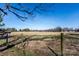 Expansive rural field marked with a wire fence and a clear blue sky at 169 Eagle Mills Rd, Harmony, NC 28634