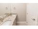 Well-lit bathroom with double sink granite vanity, tiled floors, and modern fixtures at 1766 15Th Street Ne Pl, Hickory, NC 28601