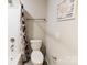 Cozy bathroom features a shower with a modern curtain, a toilet, and neutral walls at 1766 15Th Street Ne Pl, Hickory, NC 28601