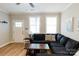 Cozy living room featuring hardwood floors, natural light, and a comfortable sectional sofa at 1766 15Th Street Ne Pl, Hickory, NC 28601