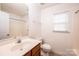 Bright bathroom with a white sink vanity, toilet, and shower, illuminated by a window at 1991 9Th Street Se Pl, Hickory, NC 28602