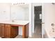 Bathroom features a vanity with wooden cabinets, a large mirror, and an open doorway to a carpeted room at 1991 9Th Street Se Pl, Hickory, NC 28602