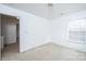 Empty bedroom with plush carpeting, natural light from a window, and an open doorway at 1991 9Th Street Se Pl, Hickory, NC 28602