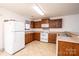 Functional kitchen with wood cabinets, white appliances and ample counter space at 1991 9Th Street Se Pl, Hickory, NC 28602