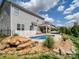 Spacious backyard with a pristine pool, inviting patio, and beautifully landscaped surroundings at 2033 Folkstone Ln, Indian Land, SC 29720