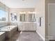 A bright bathroom features a soaking tub and double sink vanity at 2033 Folkstone Ln, Indian Land, SC 29720
