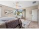Bright bedroom with ceiling fan, television and a glimpse of the home's exterior at 2033 Folkstone Ln, Indian Land, SC 29720