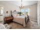 Bedroom with a wrought iron bed frame, a nearby houseplant, and natural light at 2033 Folkstone Ln, Indian Land, SC 29720