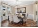 Elegant dining room featuring a stylish chandelier, large mirror, and seating for six at 2033 Folkstone Ln, Indian Land, SC 29720