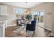 Dining room with glass table, modern lighting and access to the outdoor patio at 2033 Folkstone Ln, Indian Land, SC 29720