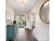 Elegant foyer with dark wood floors, wainscoting, and a decorative mirror at 2033 Folkstone Ln, Indian Land, SC 29720