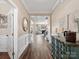 Hallway view of the main living area, decorative furniture, and hardwood floors at 2033 Folkstone Ln, Indian Land, SC 29720