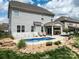 Beautiful backyard with a small inground pool, patio, landscaping, and gray two story home at 2033 Folkstone Ln, Lancaster, SC 29720