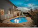 Inviting backyard with a sparkling pool, covered patio, and comfortable seating, perfect for relaxing outdoors at 2033 Folkstone Ln, Lancaster, SC 29720