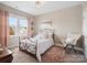 Bedroom with metal frame bed, pink curtains and a fuzzy chair at 2033 Folkstone Ln, Lancaster, SC 29720