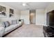 Comfortable bonus room with sofa, television, and mini fridge at 2033 Folkstone Ln, Lancaster, SC 29720