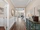 Elegant hallway showcasing hardwood floors, wainscoting, and access to the living room and other areas at 2033 Folkstone Ln, Indian Land, SC 29720