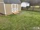 Level backyard featuring a storage shed, green grass, and wood privacy fencing at 2049 Winding Oak Rd, Rock Hill, SC 29732